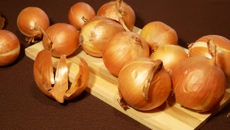 round yellow onions on wooden board on table