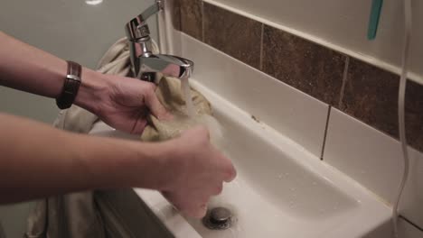 Removing-Rough-Stain-From-A-Shirt-At-The-Bathroom-Sink--Close-Up-Shot