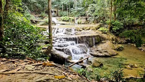 clean fresh waters cascading down erawan waterfalls flowing down a network of streams in a national park located in the province of kanchanaburi in thailand