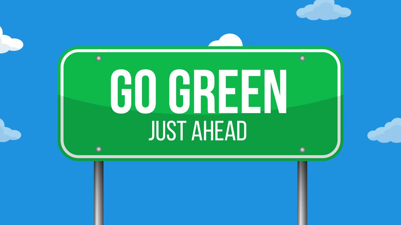 하늘 배경에 초록색 도로 표지판이 있습니다.