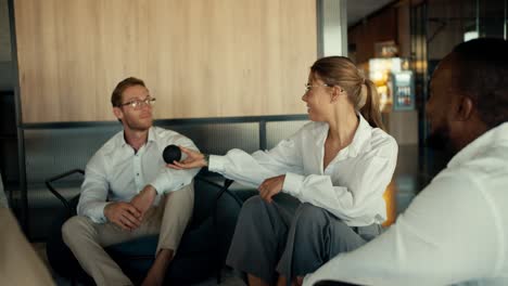 group therapy for office workers. people in a company take turns expressing their opinion and passing a black ball to each other in the office