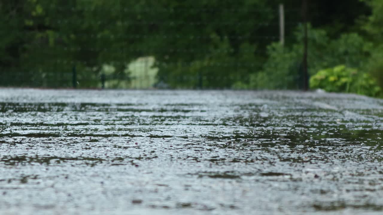 close up of rain drops falling on the ground, 4k static shot