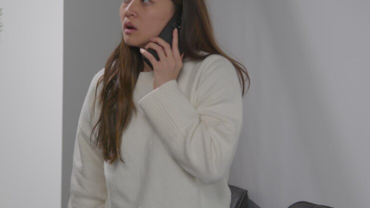 Anxious Or Stressed Woman Taking Call On Mobile Phone At Work In Office Building 2