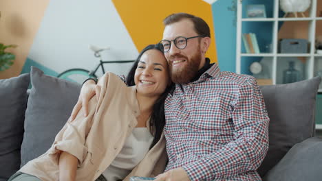 couple watching tv on couch