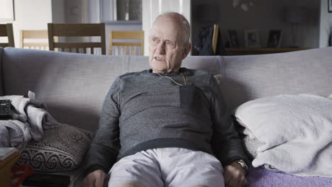 an elderly man relaxing on the couch