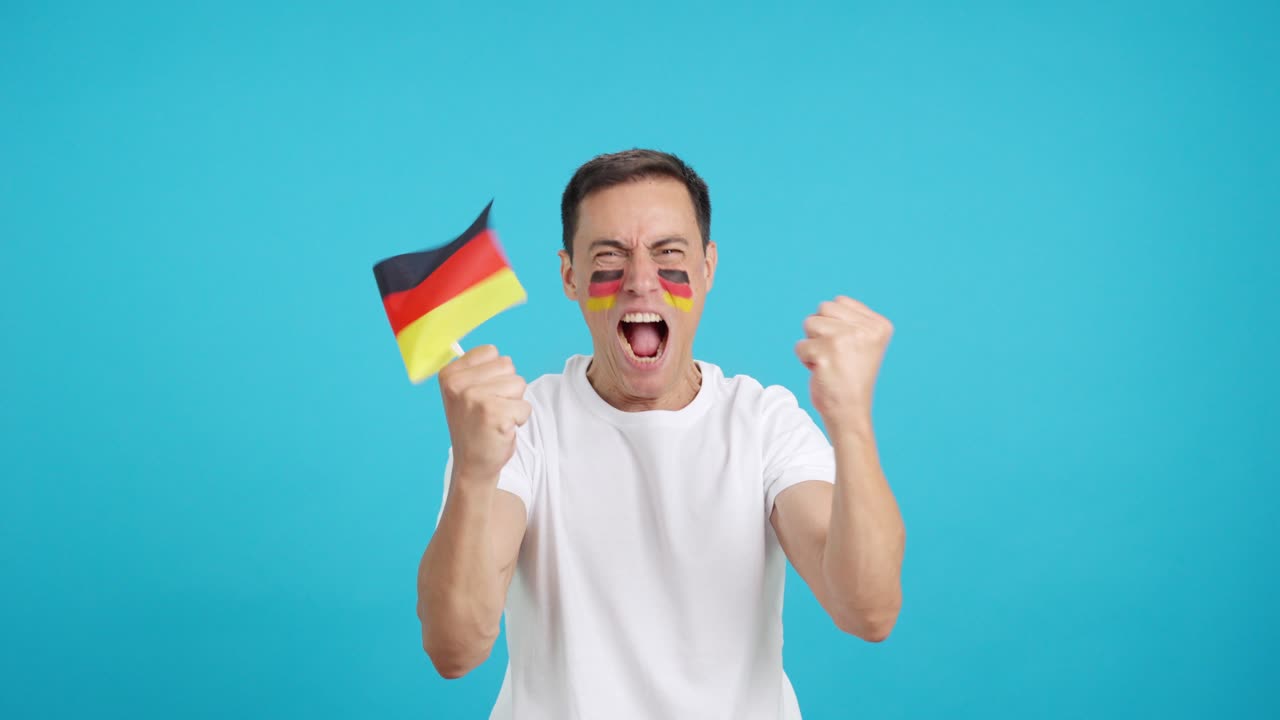 Passionate german supporter screaming and waving a national flag
