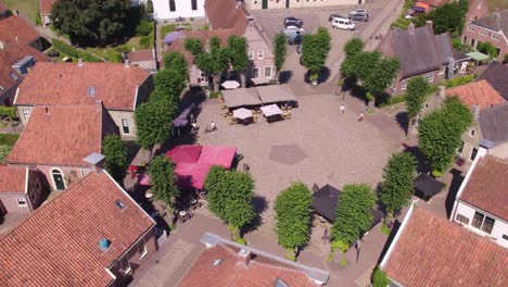 Side-panning-shot-of-the-square-of-Fortress-town-Bourtange-during-day-time,-aerial