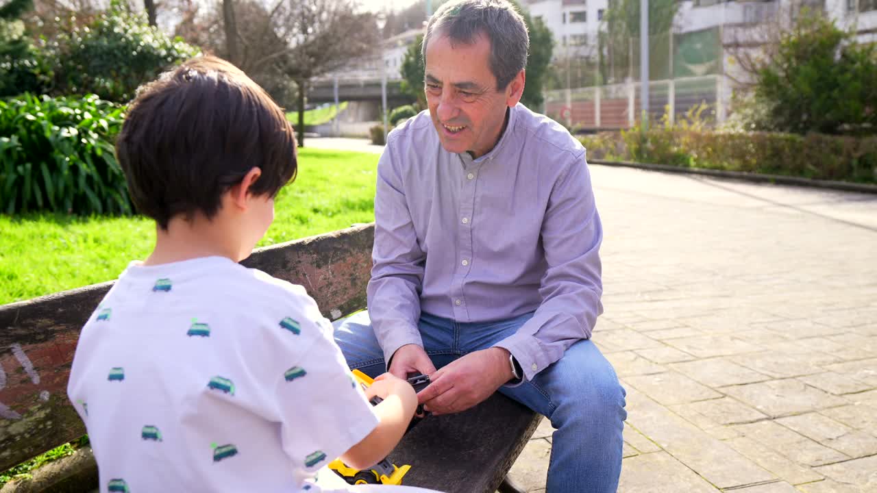 Man and Boy Talking in Park