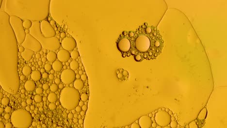 fondo abstracto dorado con gotas de aceite para tratamientos cosméticos producción de hidrógeno