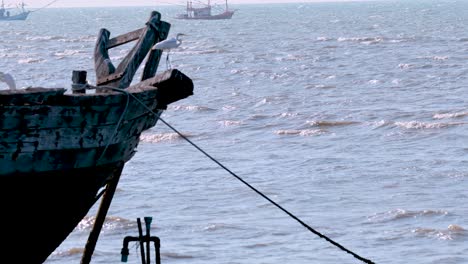 abandoned fishing boat and heron by the sea