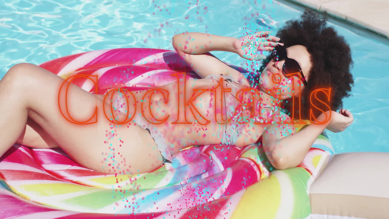 Relaxing on colorful pool float, woman holding cocktail with animation text overlay
