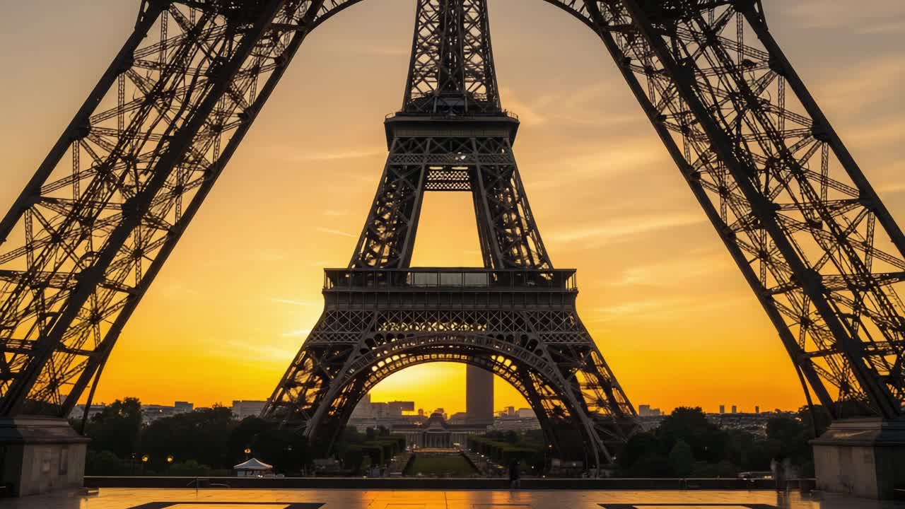 Stunning Sunset Over Iconic Structure: Captivating Views Through the Eiffel Tower&amp;#039;s Arches at Dusk, Framing a Scenic City Skyline in Illuminated Warmth