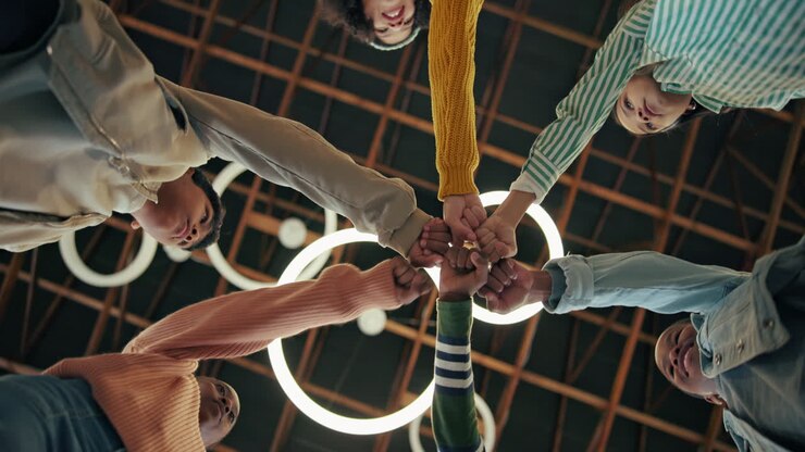 Group of people doing a fist bump