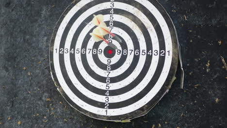 throwing darts arrows and hitting near by the target