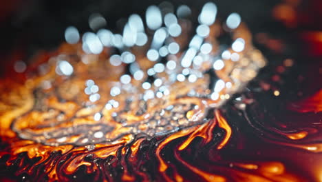 molten liquid and magnetic elements blend together in a dynamic macro shot with vivid colors