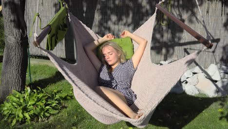 young blonde beautiful teen women sleeping and relaxing in hammock on vacation