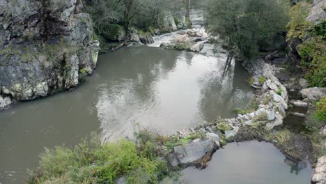 Reflections-Through-Still-Water-River-At-Rocky-Valley-In-Wilderness-Near-Oporto,-Portugal