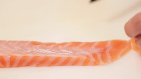 carefully slicing fresh tuna meat - kabuki sushi - slow motion