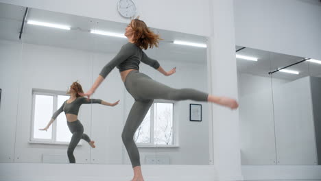 woman practicing ballet in dance studio