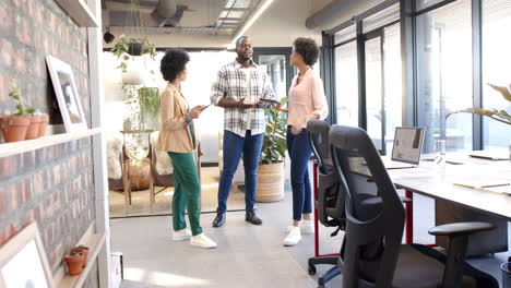 professionals discussing teamwork in a modern, diverse office setting
