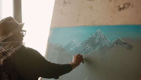 artist painting a mountain landscape