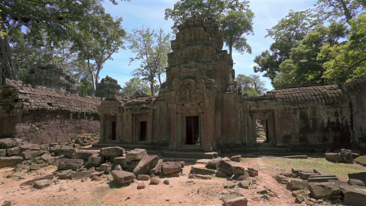 Ruined temple structure among trees in Angkor, Cambodia, establishing dolly, no people