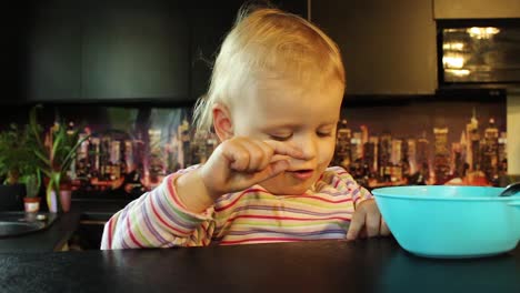 Close-up-little-girl-laughing-playing-with-soup