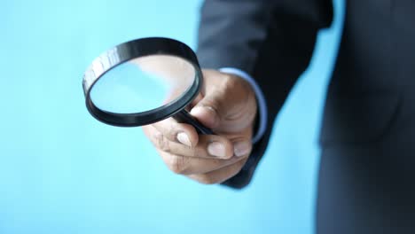 businessman holding a magnifying glass