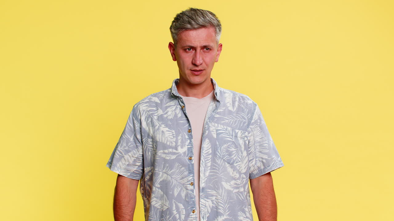 Adult man clutching chest and bending forward in pain suffering from sudden heartache health issue