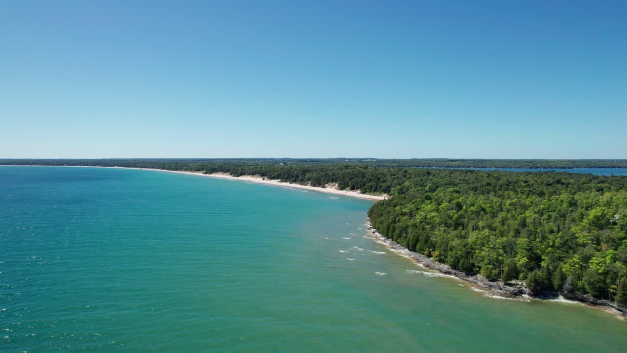 drone shot flying over lake Michigan towards whitefish dunes state park