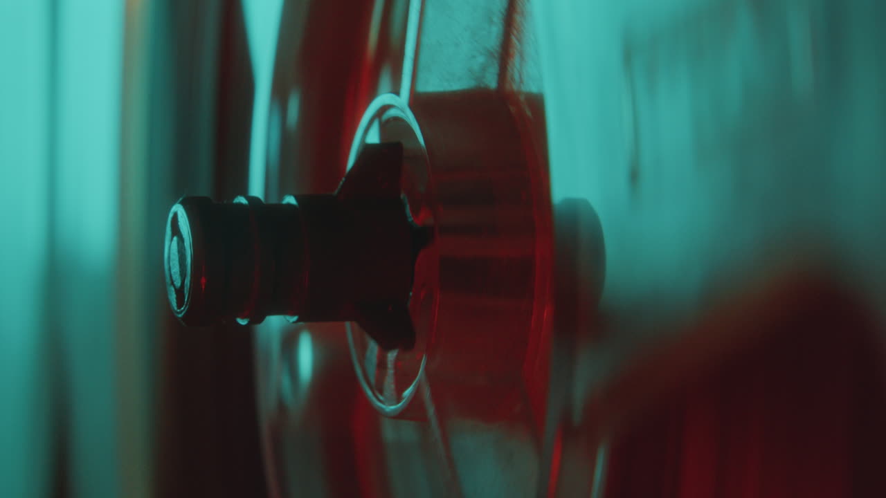 Close-Up of Reel Spindle Turning while Playing Music