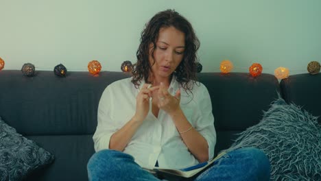 woman thinking and journaling on a couch