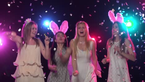 girls dancing and celebrating with confetti and party hats