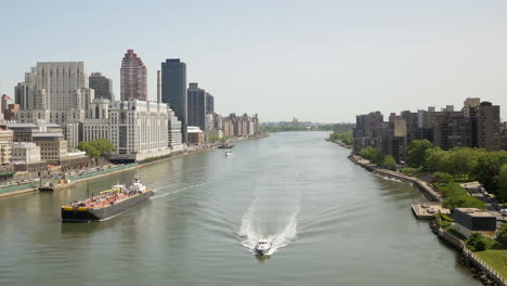 American-Modern-Urban-City-Lifestyle-With-Manhattan-Downtown-Skyscrapers-And-Boat-Ships-Moving-Cross-River-In-New-York-City-Metropolis