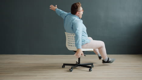 man playing on an office chair
