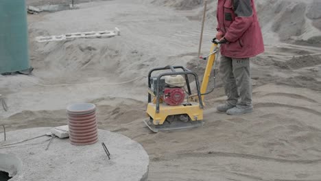 vibratory hammer power tool on the ground at the construction work. construction work on the plant