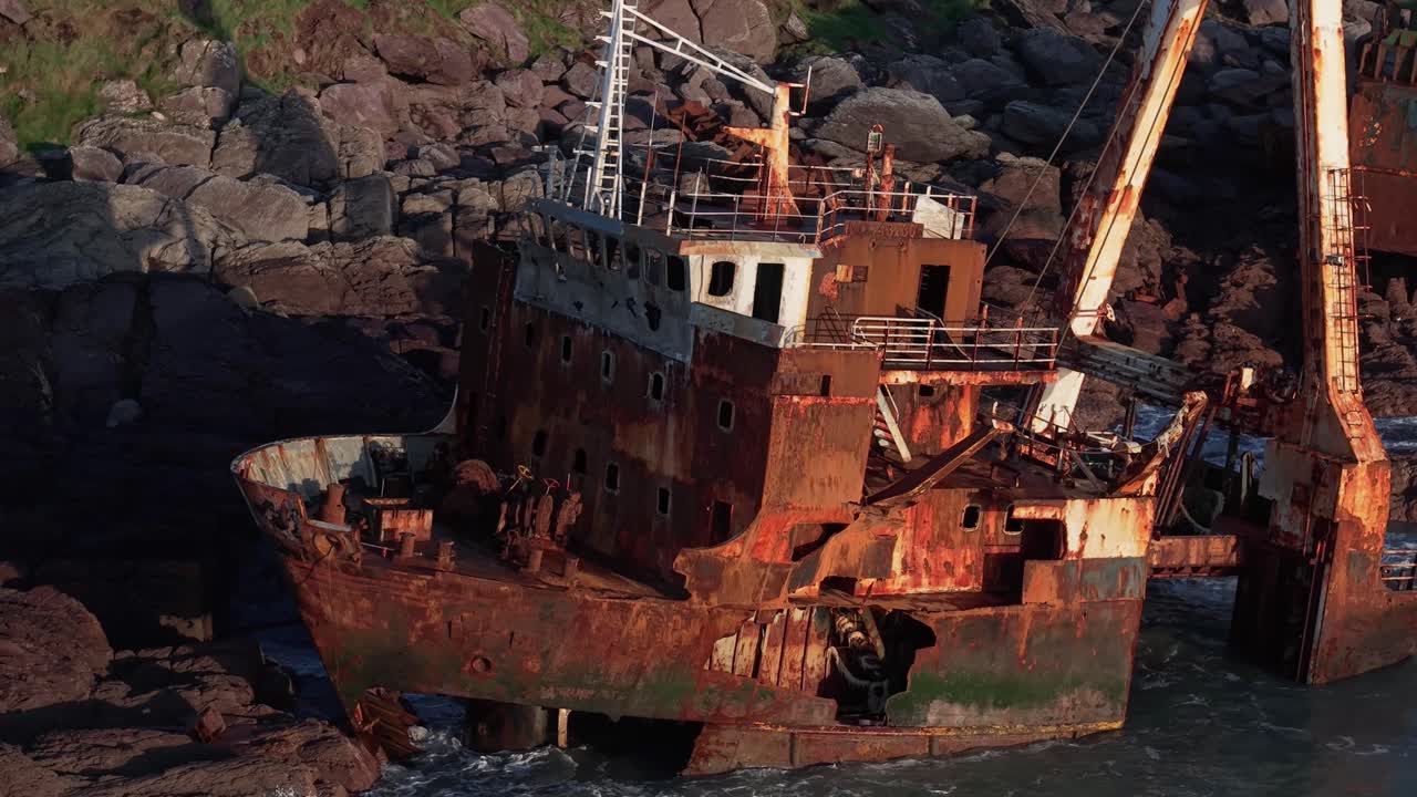 Rusty MV Alta Shipwreck During Sunset In Ballycotton, Ireland. - aerial closeup shot