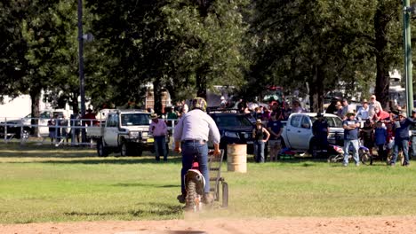 rider jumps over obstacles in front of crowd