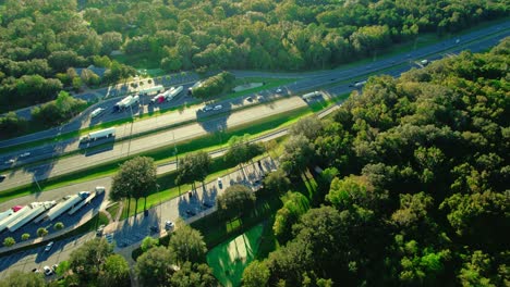 aerial over semi truck rest area in florida with highway, long-haul truckers and travelers passing through the sunshine state