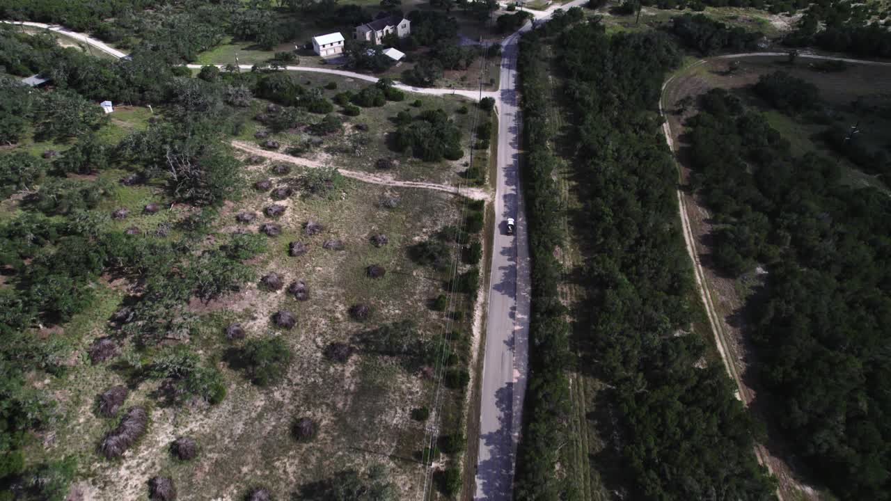aerial shot of cars driving down texas hill country roads