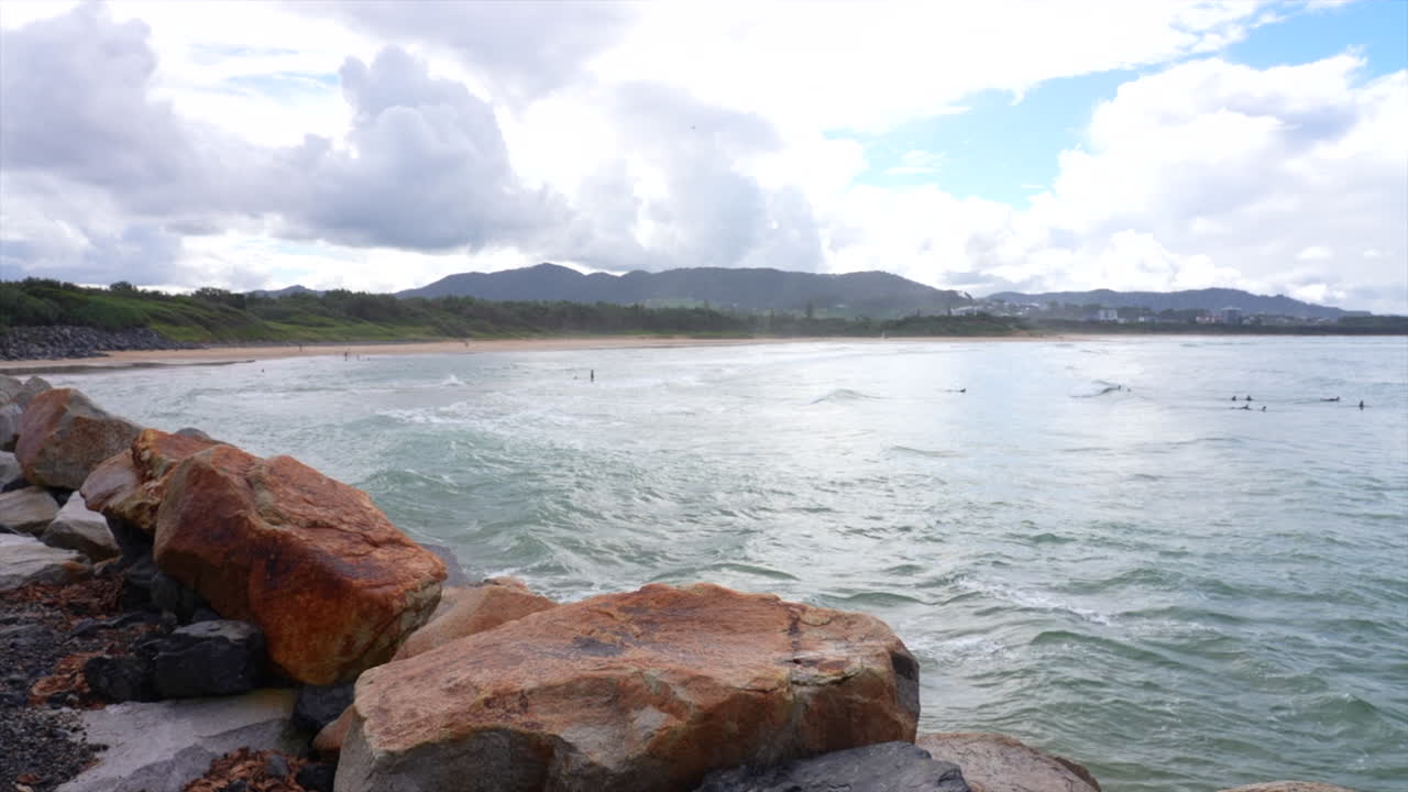 Wide sWide shot of the ocean with surfers at Coffs Harbourhot