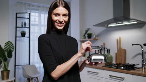woman holding a service bell in a modern kitchen