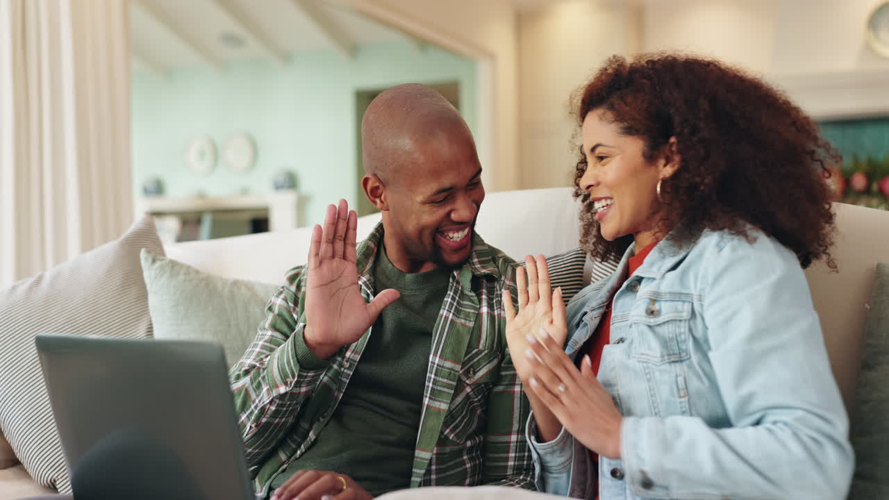 Couple using a laptop at home