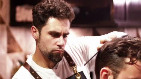 man getting his hair trimmed with razor