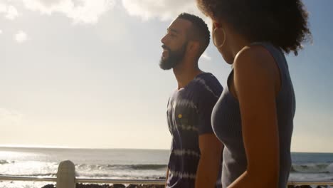 Couple-walking-hand-in-hand-at-beach-4k