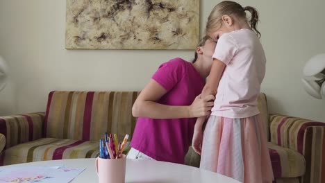 mother comforting crying daughter