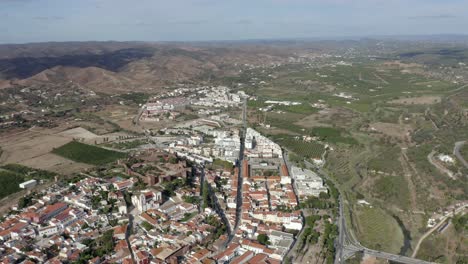 grand shot seeing the whole town of silves at great altitude from drone on a sunny day