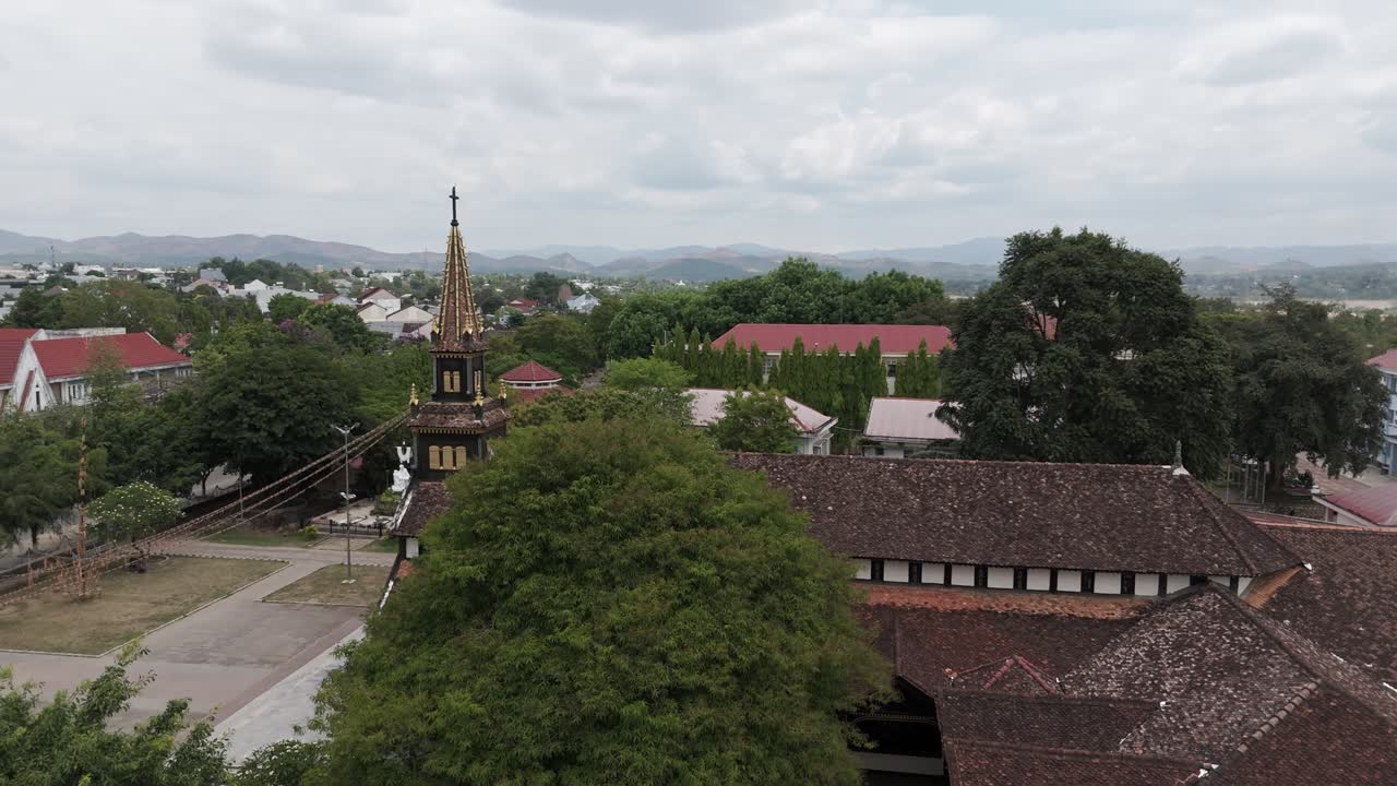 Amazing wooden cathedral of Kon Tum. Built in early XXth made by precious wood, a must to see in Vietnam. Drone is moving from left to right around the structure