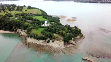 aerial view of ocean cliff, steep and rocky in music point, auckland, new zealand, rotating angle