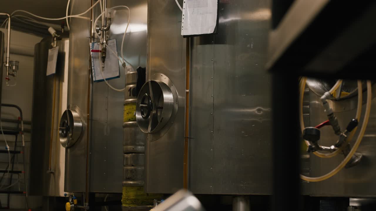 stainless steel tanks in the brewery for aged beer slider shot pan left slow mo